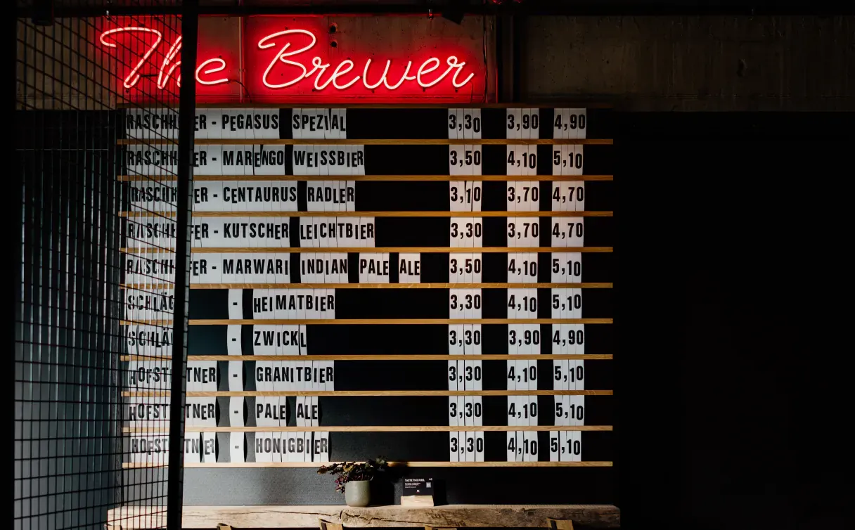 Beer board under the neon sign “The Brewer”